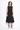 Woman wearing a black sleeveless dress on a white background