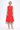 Woman wearing a red dress on a white background