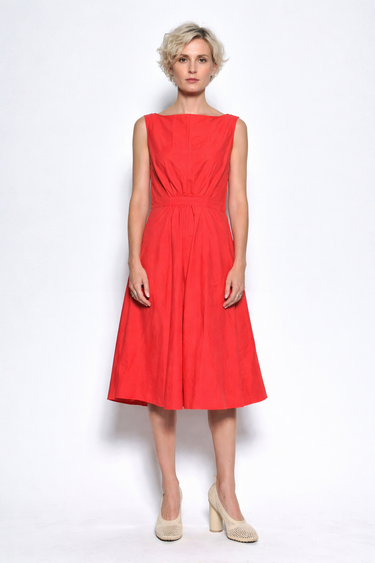 Woman wearing a red dress on a white background