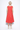 Person wearing a red sleeveless dress on a white background