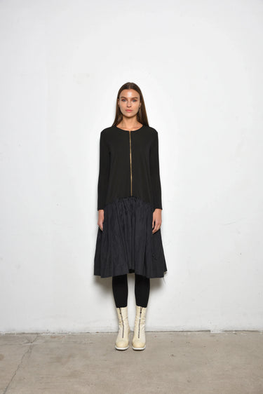 Woman wearing a black dress with a white background