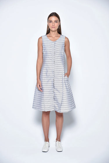 A female model wearing a sleeveless knee-length dress with horizontal black stripes and round neckline, standing against a white background.