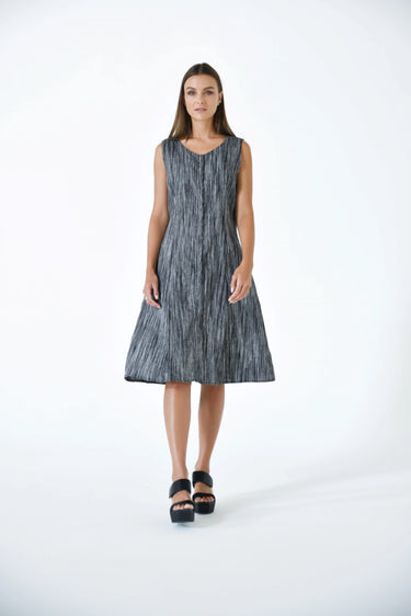A female model wearing a linen gray sleeveless knee-length dress with vertical stripes and round neckline, standing against a white background.