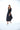 Woman wearing a black dress on a white background