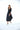 Woman wearing a black dress on a white background