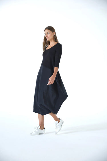 Woman wearing a black dress on a white background