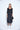 Woman wearing a black dress on a white background