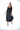 Woman wearing a black dress with a white background