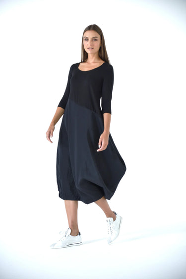 Woman wearing a black dress with a white background