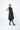 Woman wearing a black sleeveless dress on a white background