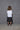 A model wearing a white boxy shirt with black strokes and black culotte pants.