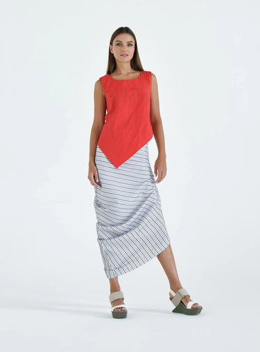 A female model wearing a Red sleeveless top, uneven hem, Black horizontal striped asymmetrical skirt and sandals against a white background