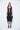 Woman wearing a black sleeveless dress on a white background