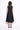 Woman wearing a black sleeveless dress on a white background
