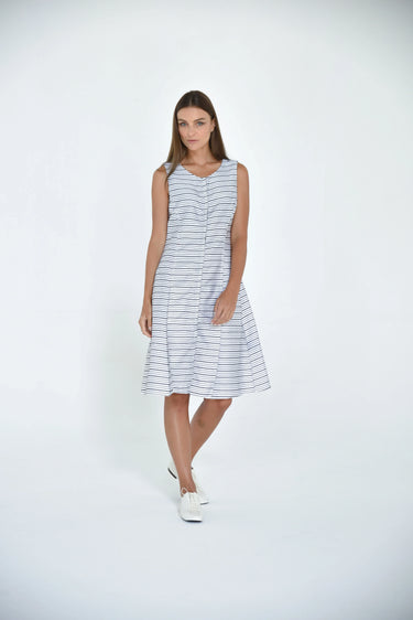 A female model wearing a sleeveless knee-length dress with horizontal black stripes and round neckline, standing against a white background.