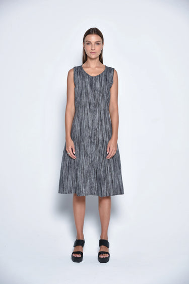 A female model wearing a linen gray sleeveless knee-length dress with vertical stripes and round neckline, standing against a white background.