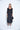 Woman wearing a black dress on a white background