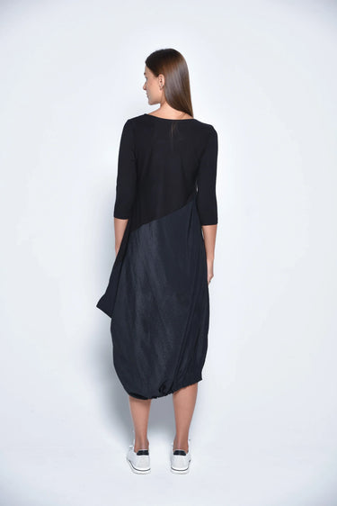 Woman wearing a black dress with a white background