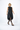 Woman wearing a black sleeveless dress on a white background