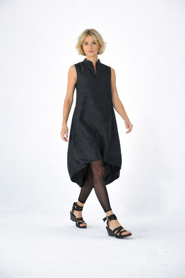 Woman wearing a black sleeveless dress on a white background