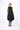 Woman wearing a black sleeveless dress on a white background