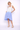 Woman wearing a white and blue gradient dress on a white background