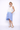 Woman wearing a white and blue dress on a white background