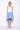 Woman wearing a white and blue dress on a white background