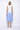 Woman wearing a white and blue dress on a white background