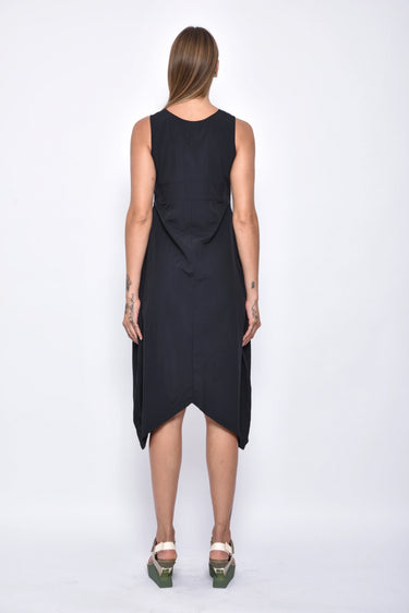 Black sleeveless dress worn by a person on a white background