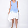 A female model wearing a sleeveless, hand-dyed blue and white ombre dress with a hi-low hem and racerback.