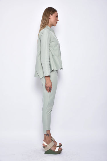 Woman wearing a light green outfit on a white background