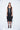 Woman wearing a black sleeveless dress on a white background