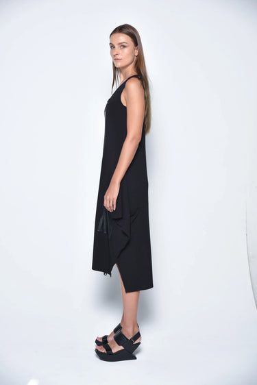 Woman wearing a black sleeveless dress on a white background